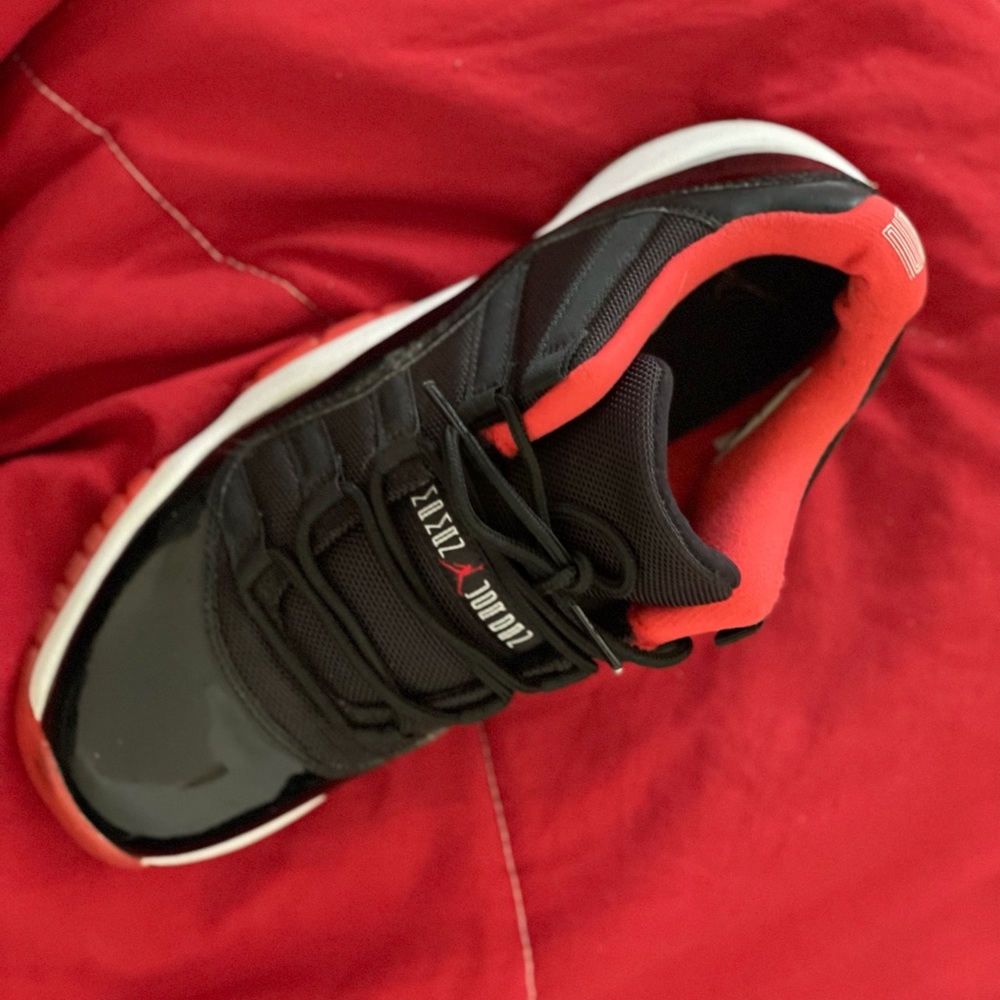 Red black and white Jordan 11s